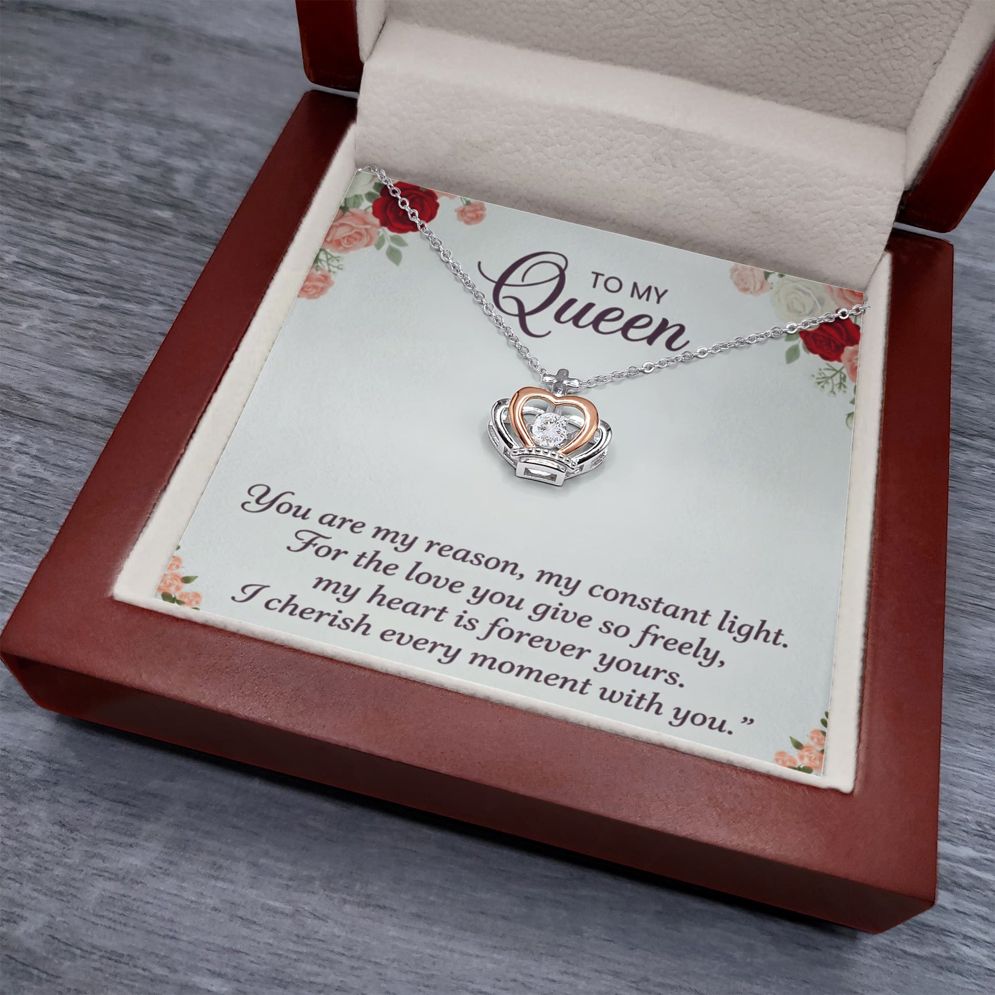Detailed close-up of crown pendant necklace showing fine craftsmanship