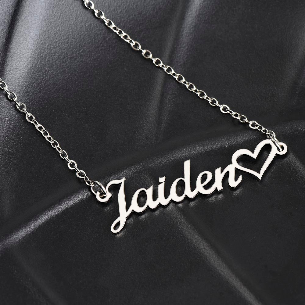Close-up of custom engraved name on heart pendant necklace
