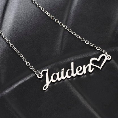 Close-up of custom engraved name on heart pendant necklace