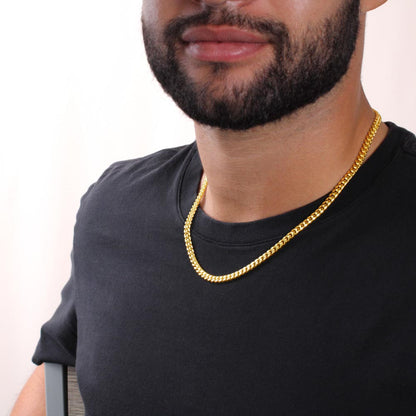 Cuban link chain necklace laid flat on surface representing Father's Day gift jewelry