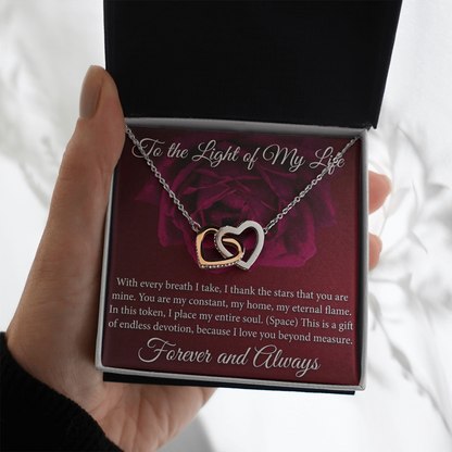 Anniversary gift necklace featuring intertwined hearts