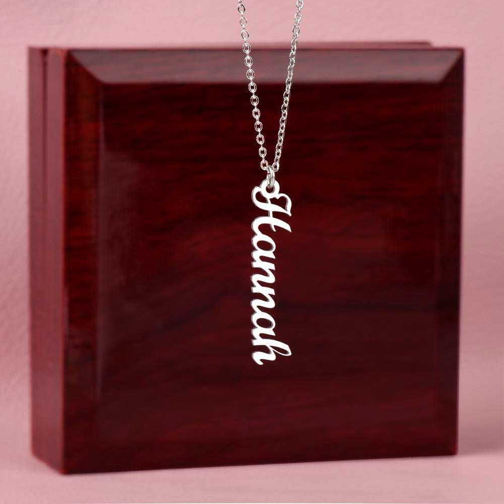 Fine gold chain attached to vertical engraved name pendant