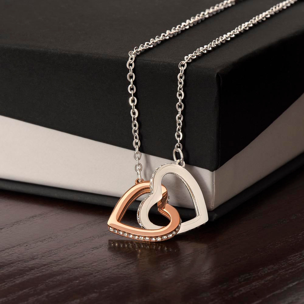 Gold interlocking hearts necklace symbolizing love and connection for couples