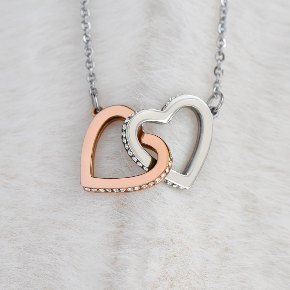 Elegant gift box containing interlocking hearts necklace for mom