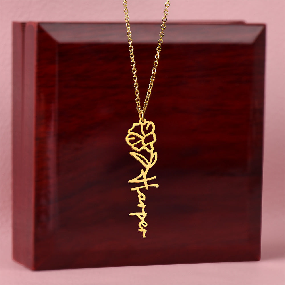 Gold floral name necklace showing custom engraved name with flower style design