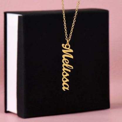Close-up detail of engraved vertical name on bar necklace