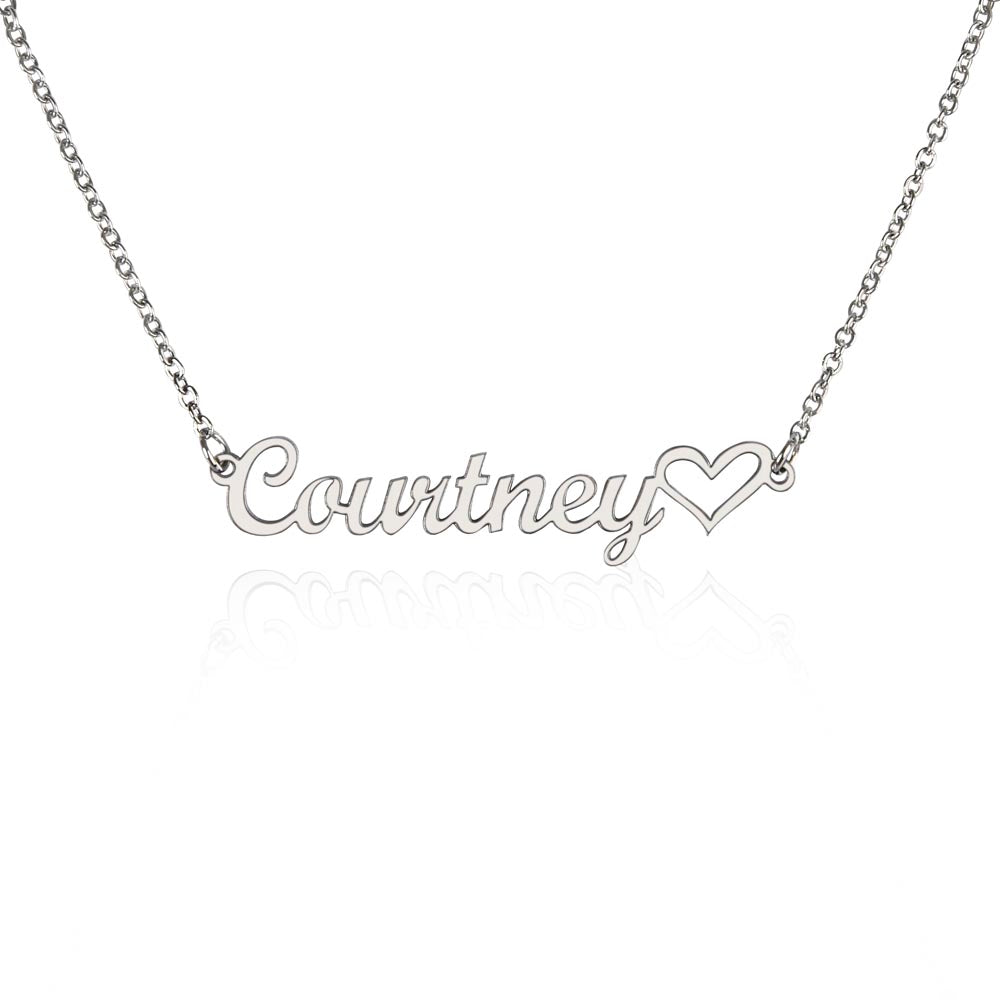 Close-up of heart-shaped necklace engraved with personalized name