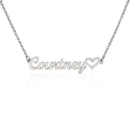 Close-up of heart-shaped necklace engraved with personalized name