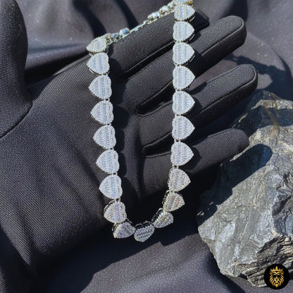 Luxury iced out baguette heart necklace displayed on black background
